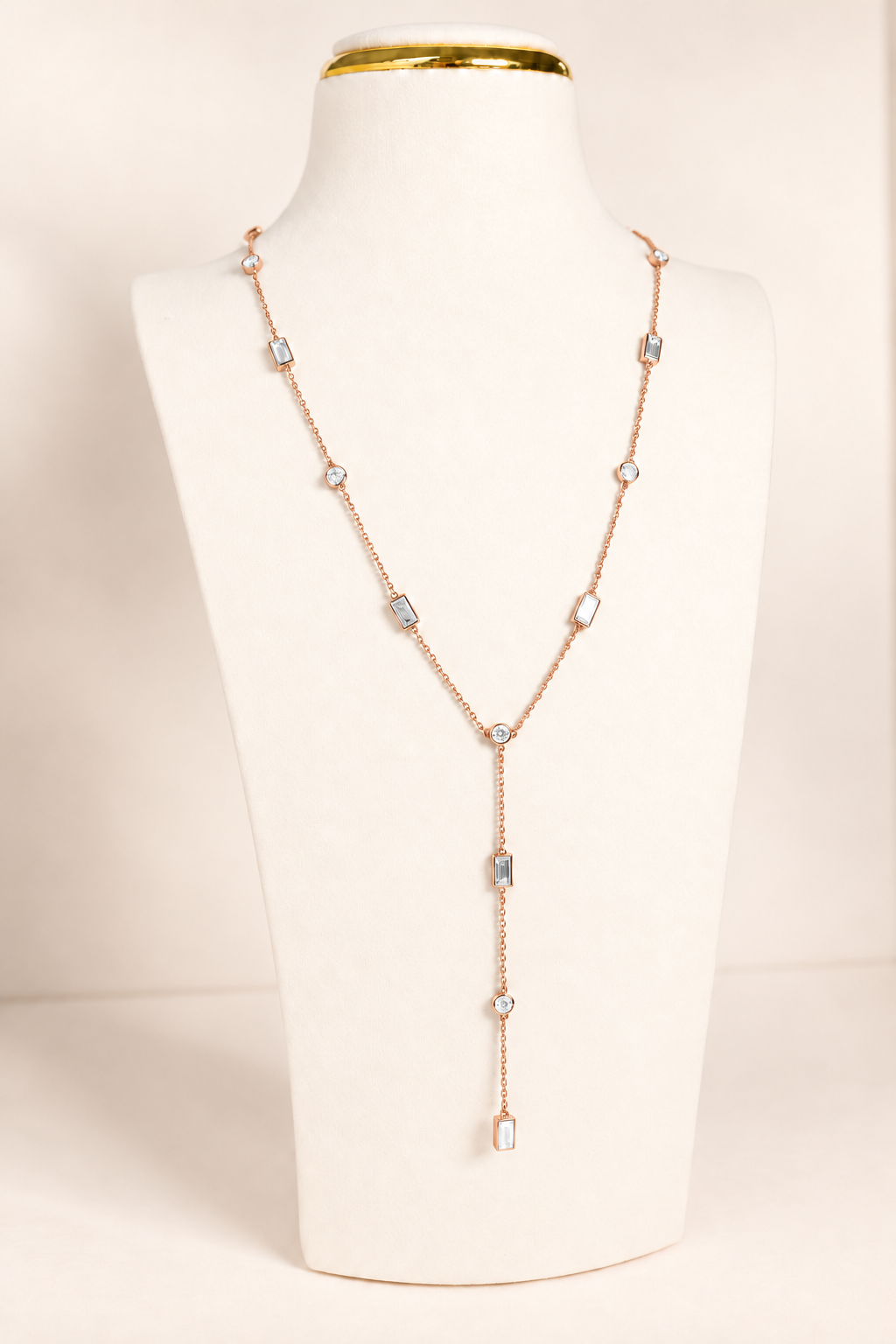 Delicate A. Atelier Signature Lariat in 18K rose gold with alternating round and baguette diamonds and a cascading drop.