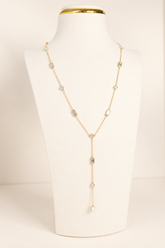 Delicate A. Atelier Signature Lariat in 18K yellow gold with alternating round and baguette diamonds and a cascading drop.