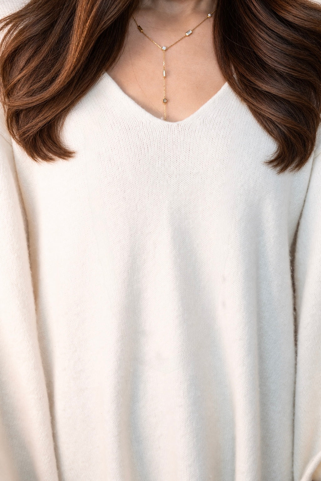 Delicate A. Atelier Signature yellow gold diamond lariat worn over a white blouse, showing its full cascading drop.