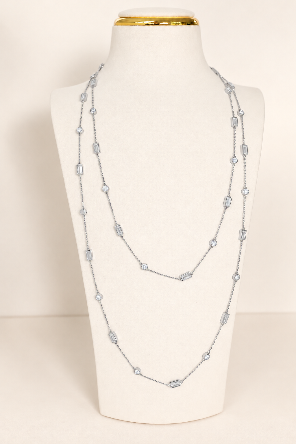 Delicate A. Atelier Signature Long Necklace in 18K white gold, doubled on a cream necklace stand.