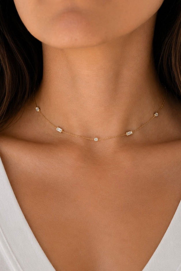 Front view of the delicate A. Atelier Signature yellow gold diamond choker worn snug at the neckline.